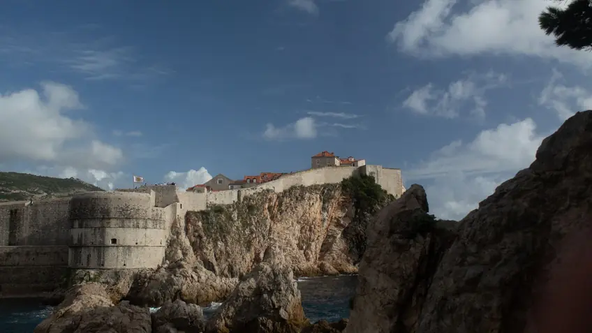 Explore the stunning medieval fortress in Dubrovnik, Croatia, set against the rugged coastal cliffs and blue skies.