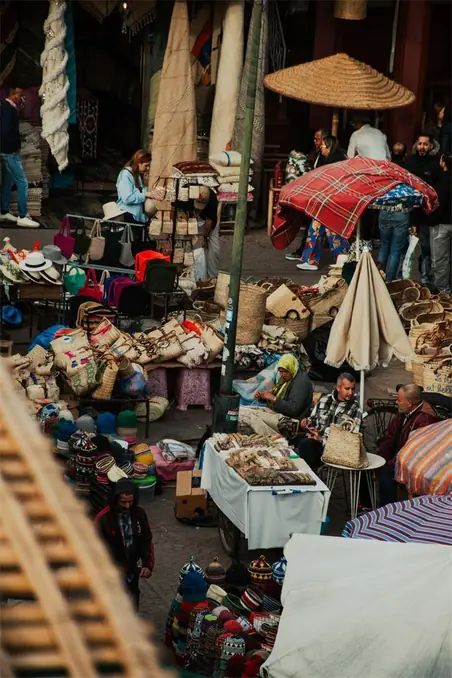 Explore the bustling souk in Marrakech, capturing the lively atmosphere of a traditional Moroccan marketplace.