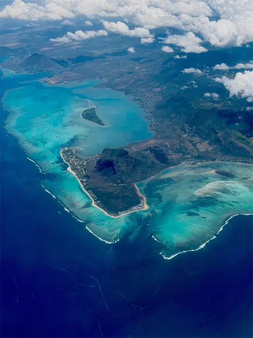 Stunning aerial view of Mauritius with vibrant turquoise waters and lush landscapes.