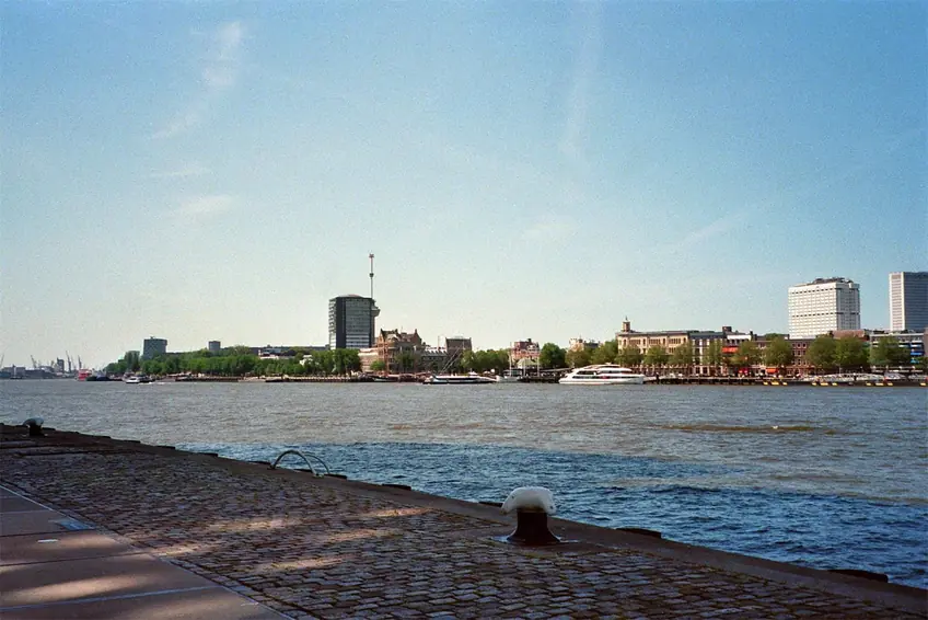 Explore the stunning urban landscape and river in Rotterdam, showcasing architectural beauty and city life.