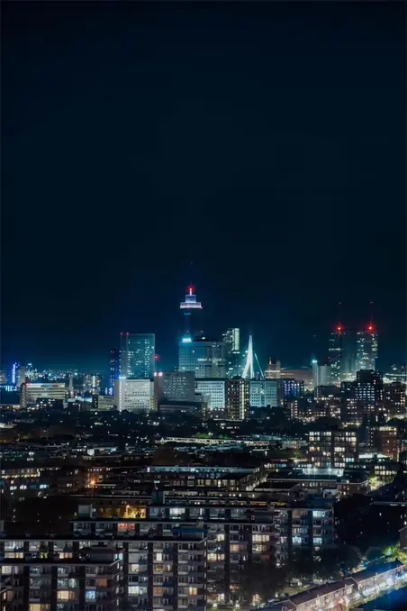 Stunning night view of Rotterdam's dynamic skyline, showcasing modern architecture and city lights.