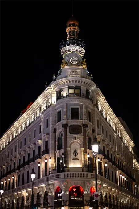 Captivating night view of the iconic Metropolis Building in Madrid, beautifully lit against the dark sky.