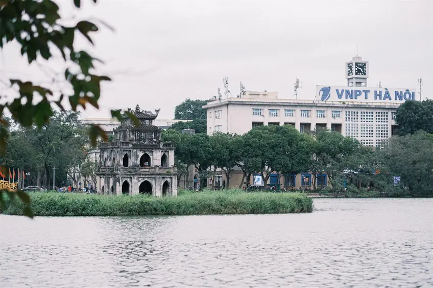 Scenic view of Hoàn Kiếm Lake with Turtle Tower and VNPT building in Hanoi, Vietnam.